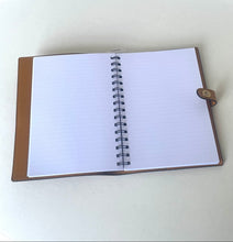 Load image into Gallery viewer, An open spiral-bound notebook with lined white pages and a brown cover, photographed on a plain light surface.
