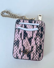 Load image into Gallery viewer, A Coach crossbody phone bag featuring a pink and black snakeskin pattern, a gold-tone chain strap, and a gold logo on the front, set against a plain light background.