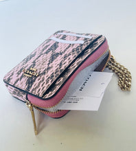 Load image into Gallery viewer, A Coach zippered pouch in a pink and black snakeskin pattern, featuring gold-tone hardware, a gold chain strap, and a white brand tag still attached.