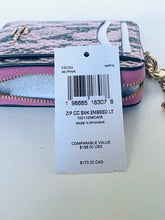 Load image into Gallery viewer, A pink and gray patterned zippered wallet with gold-tone hardware, shown with a white retail price tag in front. The tag reads CEC53 IM/PINK and lists a comparable value of $138.