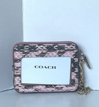 Load image into Gallery viewer, A Coach zip-around card holder wallet featuring a pink and black snakeskin pattern, a clear ID window with the black COACH logo, and a gold-tone chain strap, set against a light gray background.