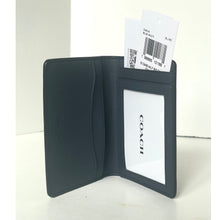 Load image into Gallery viewer, Black leather wallet with Coach branding on a white background