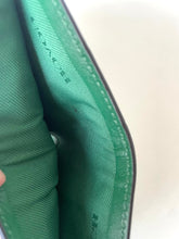 Load image into Gallery viewer, Close-up of the interior lining of a green wallet or card case, showing the green fabric texture and stitching along the edge.