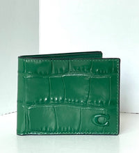 Load image into Gallery viewer, A green bifold wallet with an embossed crocodile pattern and a debossed 'C' logo on the front, displayed on a light gray surface against a white background.