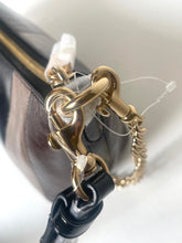 Load image into Gallery viewer, Close-up detail of a dark brown leather handbag featuring a prominent gold-tone chain link clasp and a black leather strap attachment.