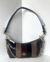 Load image into Gallery viewer, A Coach crescent-shaped shoulder bag with vertical stripes in black, brown, and dark brown, featuring a gold-tone chain strap and a black leather shoulder strap wrapped in protective plastic.