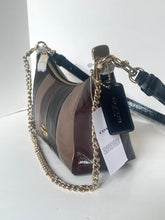 Load image into Gallery viewer, A Coach shoulder bag in brown and black patent leather with a gold-tone chain strap and a black leather brand tag.