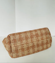 Load image into Gallery viewer, A woven straw clutch bag with a textured pattern of light tan and medium brown, photographed on a plain white background.