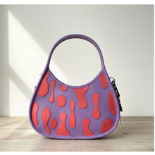 Load image into Gallery viewer, Purple handbag with red pattern on a wooden surface
