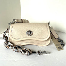 Load image into Gallery viewer, Beige handbag with chain detail on a white surface