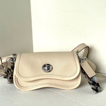 Load image into Gallery viewer, Beige handbag with a chain detail on a light surface