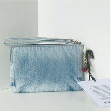 Load image into Gallery viewer, Blue tie-dye pouch with a red charm on a white surface