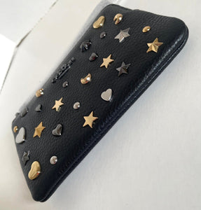 Black phone case with gold and silver studs on a white background
