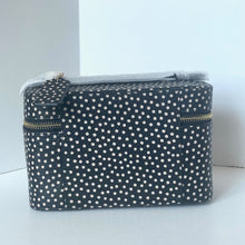 Load image into Gallery viewer, Navy blue cosmetic bag with white polka dots on a light gray background