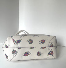 Load image into Gallery viewer, A small zippered cosmetic pouch or bag in off-white pebbled faux leather, featuring a scattered print of vintage-style flying birds in muted pink, purple, and brown tones, with a silver-tone metal handle.