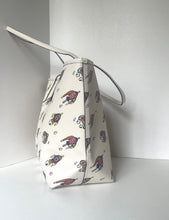 Load image into Gallery viewer, An off-white canvas bucket bag with a colorful cartoon dog print, featuring a single shoulder strap, photographed against a plain white background.