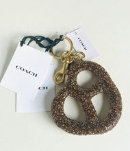 Load image into Gallery viewer, Coach keychain with glittery design on a white background