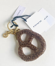 Load image into Gallery viewer, Coach keychain with glittery design on a white background