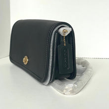 Load image into Gallery viewer, Black handbag with gold accents on a white background