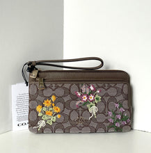 Load image into Gallery viewer, Coach wallet with floral designs on a white background