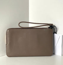 Load image into Gallery viewer, Brown leather wristlet on a white surface with a light gray background