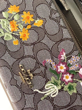 Load image into Gallery viewer, Close-up of a handbag with floral embroidery and Gucci logo.