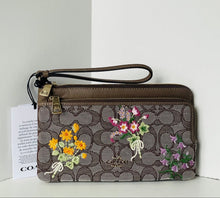 Load image into Gallery viewer, Coach wallet with floral design on a white background