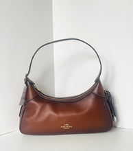 Load image into Gallery viewer, Brown leather handbag with Coach logo on a white background