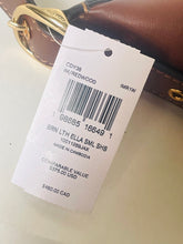 Load image into Gallery viewer, Product tag on a brown leather bag with gold hardware