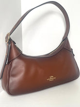 Load image into Gallery viewer, Brown handbag with visible brand logo on a light gray background