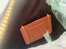 Load image into Gallery viewer, Close-up of a brown leather tag with text on a black background