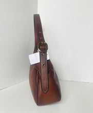 Load image into Gallery viewer, Brown leather handbag with a tag on a white background