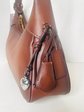 Load image into Gallery viewer, Brown leather handbag with decorative elements on a white background