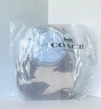 Load image into Gallery viewer, A Coach New York handbag in clear plastic packaging, featuring a circular light blue leather patch on a gray and beige patterned textile body.