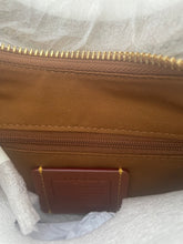 Load image into Gallery viewer, Close-up of a brown nylon pouch or wallet interior with a gold zipper and a brown leather brand patch reading 'MISONIC'.