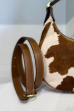 Load image into Gallery viewer, Brown and white cowhide shoulder bag with a matching adjustable brown leather strap, displayed on a light surface with a yellow 'Emmasbag' text overlay.
