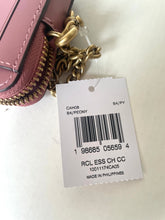 Load image into Gallery viewer, A close-up of a pink leather wallet or clutch with gold-tone hardware and a white product tag attached. The tag shows a barcode and text including 'RCL ESS CH CC' and 'MADE IN PHILIPPINES'.