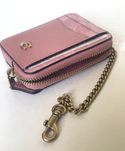 Load image into Gallery viewer, A small pink leather zip card holder wallet with gold-tone hardware, including a chain strap and clasp, on a plain light background.
