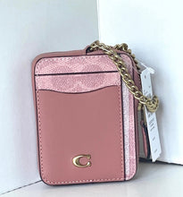 Load image into Gallery viewer, A pink Coach crossbody card holder featuring a smooth leather front pocket, a pink snakeskin patterned top section, a gold-tone 'C' logo, and a gold chain strap, shown with a white hangtag against a white background.