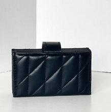 Load image into Gallery viewer, A black quilted leather clutch bag with a diagonal stitched pattern and a top handle, set against a minimalist white background.