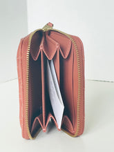 Load image into Gallery viewer, An open salmon pink quilted leather wallet with gold-tone zippers and interior card slots, shown on a clean white background.