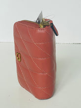 Load image into Gallery viewer, A small quilted leather zip pouch in a muted terracotta pink color, featuring diagonal stitching, gold-tone hardware, and a small attached plastic tag.