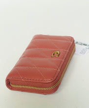 Load image into Gallery viewer, A quilted coral pink leather zip-around wallet with gold-tone hardware and a small gold logo ring, shown on a plain white background with a price tag attached.