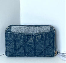 Load image into Gallery viewer, A dark blue quilted zip-around wallet with a textured glittery silver-gray front pocket, resting on a white surface against a white background.