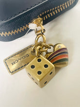 Load image into Gallery viewer, Gold charm with die and heart on a Coach bag