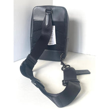 Load image into Gallery viewer, Black leather bag with attached strap on a white background