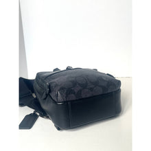 Load image into Gallery viewer, Black leather bag with brand logo on a white background
