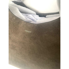 Load image into Gallery viewer, Close-up of a brown leather Coach bag with a white interior.