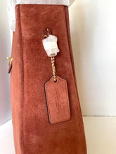 Load image into Gallery viewer, Brown textured bag with a decorative tag and bead on a white background