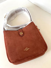Load image into Gallery viewer, Brown Coach handbag on a white surface